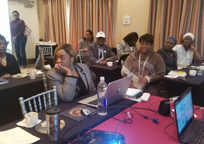 Conference meeting with participants and laptops.