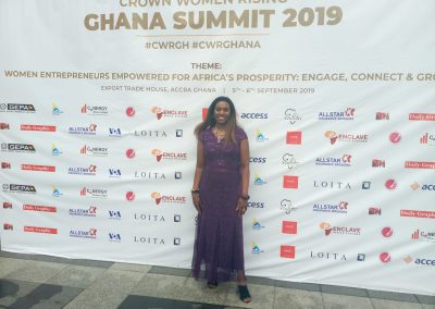 Woman at Ghana Summit 2019 event backdrop.