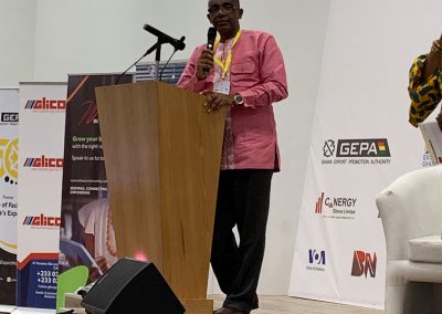 Man speaking at a podium during event.