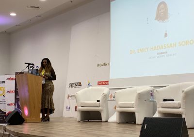 Speaker presenting at a conference stage.