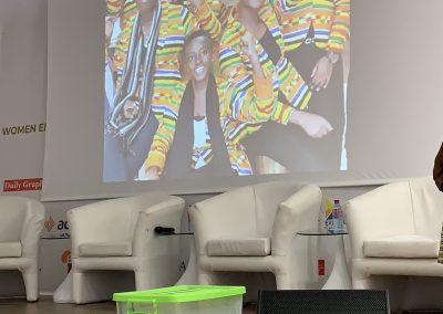 People in colorful jackets on display screen.