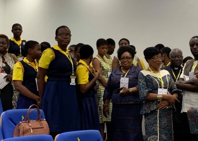 Group of people standing in a room.
