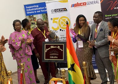 Group unveiling plaque with Ghanaian flag.