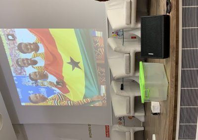 Projected image of people with Ghana flag.